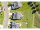 An aerial view of homes with well-maintained lawns, a lake and backyard fire pit area at 543 Pendleton Dr, Moncks Corner, SC 29461