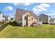 Spacious backyard with lush grass, a charming dog house, and a view of the home's exterior at 543 Pendleton Dr, Moncks Corner, SC 29461