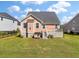 Well-maintained backyard with green grass, and a charming peach colored home with a small dog house at 543 Pendleton Dr, Moncks Corner, SC 29461