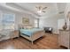 Bedroom with tray ceilings, wood floors, ceiling fan, and ensuite bathroom at 543 Pendleton Dr, Moncks Corner, SC 29461