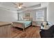 Bedroom with tray ceilings, wood floors, ceiling fan, and ensuite bathroom at 543 Pendleton Dr, Moncks Corner, SC 29461