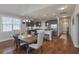 Open concept dining room and kitchen with hardwood floors, bright natural light, and modern fixtures at 543 Pendleton Dr, Moncks Corner, SC 29461