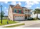 Side view of a two-story home with a manicured lawn and a two car garage at 543 Pendleton Dr, Moncks Corner, SC 29461