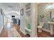 Hallway view leading into the living room and dining area, with a half bathroom at 543 Pendleton Dr, Moncks Corner, SC 29461