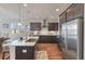Kitchen featuring stainless appliances, dark cabinets, subway tile backsplash, granite countertops, and hardwood floors at 543 Pendleton Dr, Moncks Corner, SC 29461