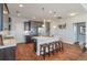 Bright kitchen with dark cabinets, stainless appliances, large island with breakfast bar, and hardwood floors at 543 Pendleton Dr, Moncks Corner, SC 29461