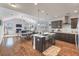 Open-concept kitchen and living room with vaulted ceilings, stainless steel appliances, and a cozy fireplace at 543 Pendleton Dr, Moncks Corner, SC 29461