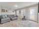 Relax in this cozy living room with a plush gray sectional, stylish rug, and plenty of natural light at 543 Pendleton Dr, Moncks Corner, SC 29461