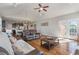 Cozy living room with vaulted ceilings, hardwood floors, and open floor plan to kitchen and dining area at 543 Pendleton Dr, Moncks Corner, SC 29461