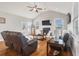 Open living room with vaulted ceilings, fireplace, wood floors, and lots of natural light at 543 Pendleton Dr, Moncks Corner, SC 29461