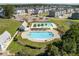 Aerial shot of a community pool and playground next to many houses and a pond at 543 Pendleton Dr, Moncks Corner, SC 29461