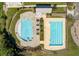 Overhead view of community pools, white lounge chairs, playground, and manicured green space at 543 Pendleton Dr, Moncks Corner, SC 29461