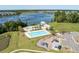 Aerial view showcases community pools, playground, lake, and lush greenery in a residential area at 543 Pendleton Dr, Moncks Corner, SC 29461