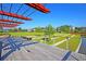 Community amphitheater with wooden deck overlooks a green lawn and stage, perfect for outdoor events and gatherings at 565 Blueway Ave, Summerville, SC 29486