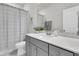 This bathroom features a gray vanity, a sink, and a shower behind a curtain at 565 Blueway Ave, Summerville, SC 29486