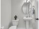 Elegant powder room with a pedestal sink, decorative mirror, and modern fixtures at 565 Blueway Ave, Summerville, SC 29486