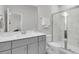 This bathroom features a gray vanity and a glass shower with white and gray marble tiling at 565 Blueway Ave, Summerville, SC 29486