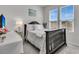 This bedroom has a wooden bedframe and two windows with blinds for natural light at 565 Blueway Ave, Summerville, SC 29486