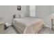 This bedroom features a simple bed and a window with white blinds at 565 Blueway Ave, Summerville, SC 29486