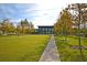 Well maintained common area of grass with walking path and building in the background at 565 Blueway Ave, Summerville, SC 29486