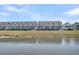 Row of blue townhomes overlooking a scenic pond at 565 Blueway Ave, Summerville, SC 29486