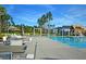 Relaxing community pool featuring pergolas, patio seating, and lovely landscaping with tall pines and palm trees at 565 Blueway Ave, Summerville, SC 29486