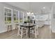Bright dining area with a table, chairs, and a view of the modern kitchen at 565 Blueway Ave, Summerville, SC 29486