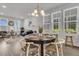 Bright dining room featuring a round table, chandelier, and seamless flow into the living area at 565 Blueway Ave, Summerville, SC 29486