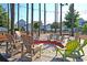 Community fire pit with tall trees and wooden Adirondack chairs for outdoor relaxation and gatherings at 565 Blueway Ave, Summerville, SC 29486