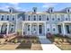 Attractive two-story townhouse with a covered porch and manicured front yard at 565 Blueway Ave, Summerville, SC 29486