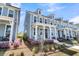 Charming two-story home with a welcoming front porch and beautiful landscaping at 565 Blueway Ave, Summerville, SC 29486