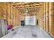 Unfinished attached garage with concrete flooring and exposed wooden beams at 565 Blueway Ave, Summerville, SC 29486