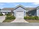 Attached two car garage with white garage door, dark hardware, and green shrubbery at 565 Blueway Ave, Summerville, SC 29486