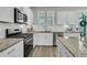 Well-equipped kitchen featuring stainless steel appliances, granite countertops, and ample cabinet space at 565 Blueway Ave, Summerville, SC 29486