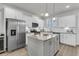 Modern kitchen with white cabinets, stainless steel appliances, and granite countertops on the center island at 565 Blueway Ave, Summerville, SC 29486