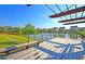 Lakeside wooden deck with bench offers a beautiful view of the community, lake, and landscaped greenery at 565 Blueway Ave, Summerville, SC 29486