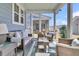 The cozy covered patio features outdoor furniture at 565 Blueway Ave, Summerville, SC 29486