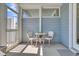 The screened-in porch has a table and seating for two with views of the backyard at 565 Blueway Ave, Summerville, SC 29486
