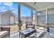 This covered patio is cozy with natural light and outdoor furniture at 565 Blueway Ave, Summerville, SC 29486