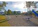 Community playground with swings and slides for children, surrounded by green spaces and neighborhood homes at 565 Blueway Ave, Summerville, SC 29486