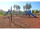 Community playground featuring a colorful blue slide and climbing structures on a mulch surface at 565 Blueway Ave, Summerville, SC 29486