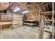 Unfinished attic space featuring insulation, exposed rafters, and a ceiling fan at 5921 Oak St, Hanahan, SC 29410