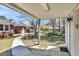 Backyard with concrete patio, manicured landscaping, storage unit and walkway to house at 5921 Oak St, Hanahan, SC 29410