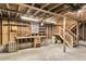 Unfinished basement featuring a workbench, shelving, and a staircase leading to the upper level at 5921 Oak St, Hanahan, SC 29410