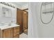 Bathroom features a wood vanity and shower with a curtain at 5921 Oak St, Hanahan, SC 29410