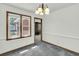 Dining room with a modern chandelier, view of the yard through the window, and entry to the living room at 5921 Oak St, Hanahan, SC 29410