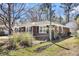 A quaint brick home with fenced yard is showcased in an exterior view, highlighting its architectural style and perimeter at 5921 Oak St, Hanahan, SC 29410