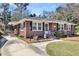 Classic brick home with black shutters, well-manicured lawn, and a welcoming entrance, reflecting traditional charm at 5921 Oak St, Hanahan, SC 29410