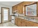 Kitchen with an oven, light wood cabinets, granite counters, and stainless steel sink at 5921 Oak St, Hanahan, SC 29410