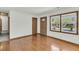 Living room featuring hardwood floors, decorative front door, window and trim at 5921 Oak St, Hanahan, SC 29410